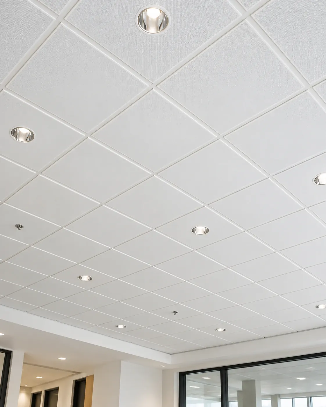 Finished suspended ceiling grid with tiles and recessed downlights