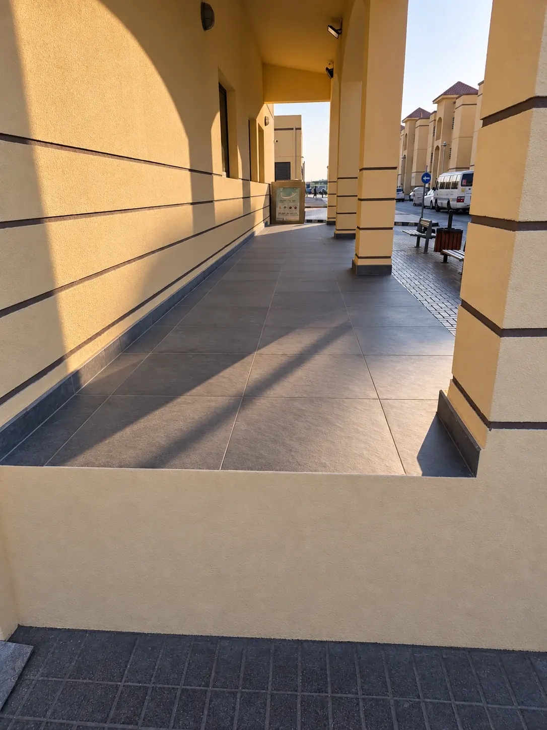 Finished porcelain tiling to a covered walkway between buildings